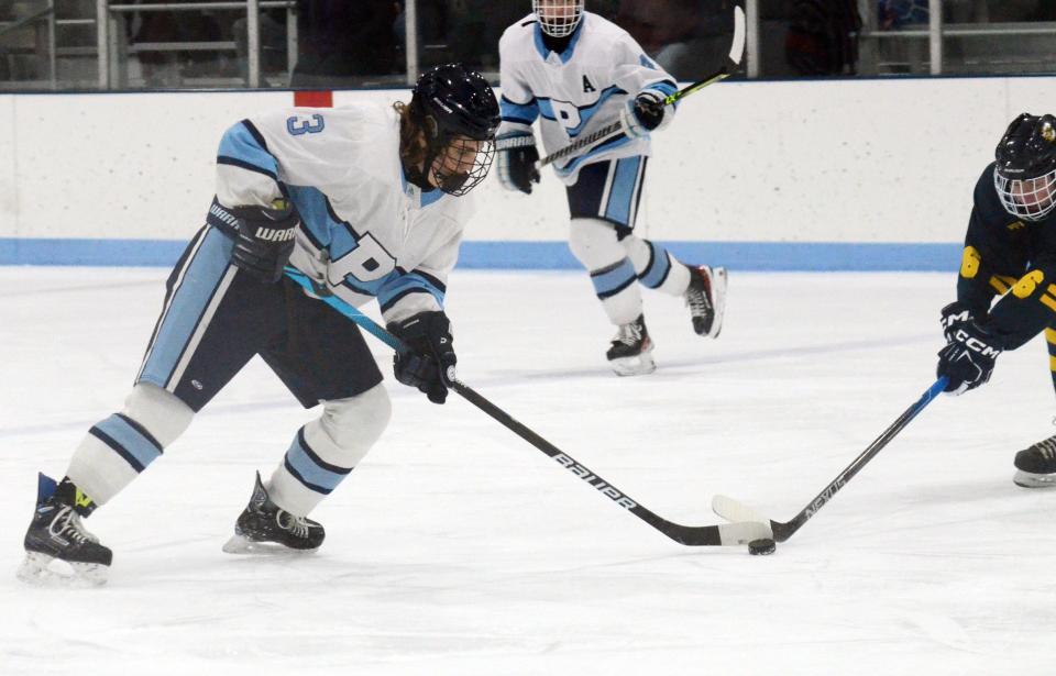 Petoskey's Tommy Guiney (3) tries to keep the puck away from a Cadillac defender during the first period of Wednesday's matchup.