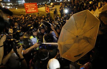 Police use pepper spray during clashes with pro-democracy protesters at a rally close to the chief executive office in Hong Kong, November 30, 2014. REUTERS/Tyrone Siu