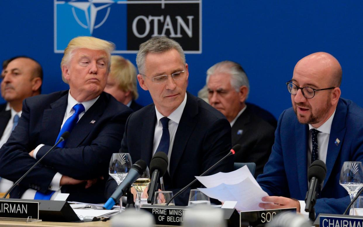 Donald Trump (L) and Jens Stoltenburg (Centre) at a Nato summit in 2017 - AFP