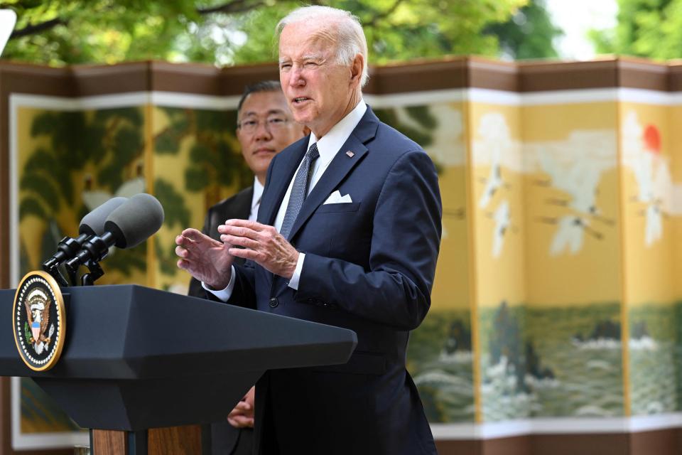 President Joe Biden speaks to the media next to Hyundai Motor Group Chairman Chung Eui-sun at a hotel in Seoul on May 22, 2022.