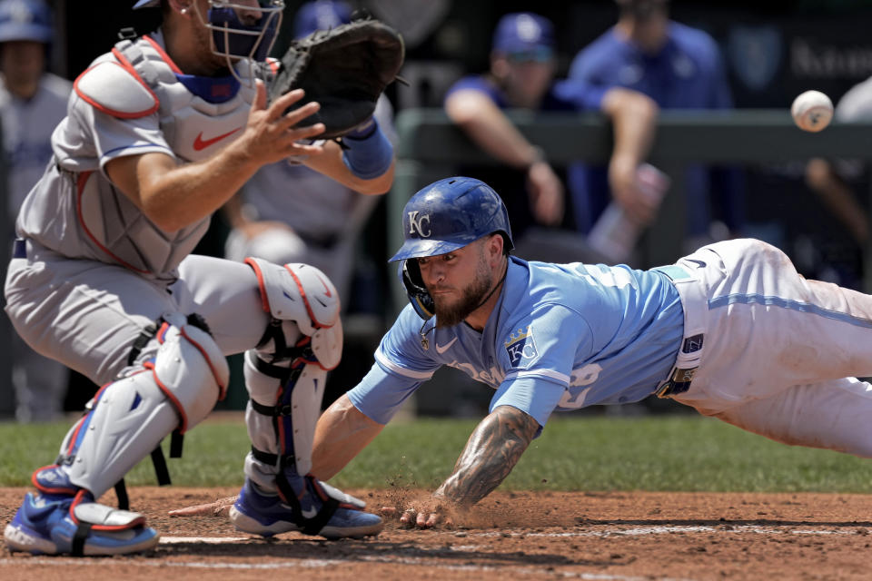 Kansas City Royals' Kyle Isbel slides home to score on a sacrifice fly hit by Bobby Witt Jr. during the fifth inning of a baseball game against the Los Angeles Dodgers Sunday, July 2, 2023, in Kansas City, Mo. (AP Photo/Charlie Riedel)