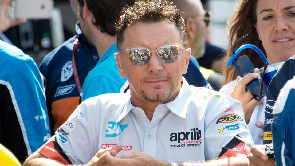 Pictured here, Fausto Gresini watches on at a motorsport event.