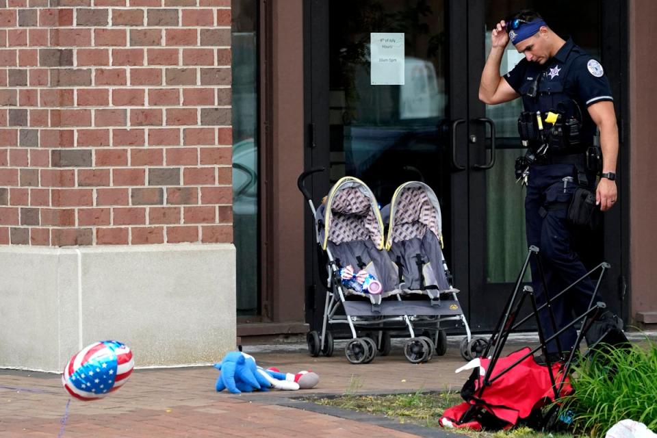 An officer reacts as a pram and other items are left strewn along the parade route (AP)