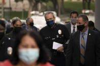 Los Angeles Police Chief Michel Moore, center, arrives for a news conference outside the Los Angeles Police Headquarters in Los Angeles Thursday, Dec. 2, 2021. Authorities in Los Angeles on Thursday announced arrests in recent smash-and-grab thefts at stores, part of a rash of organized retail crime in California. (AP Photo/Jae C. Hong)