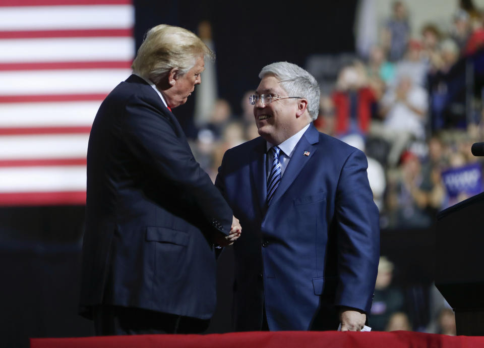 President Donald Trump, left, shakes hands with Republican Senate candidate Patrick Morrisey, right, on stage during a campaign rally at WesBanco Arena, Saturday, Sept. 29, 2018, in Wheeling, W.Va. (AP Photo/Pablo Martinez Monsivais)