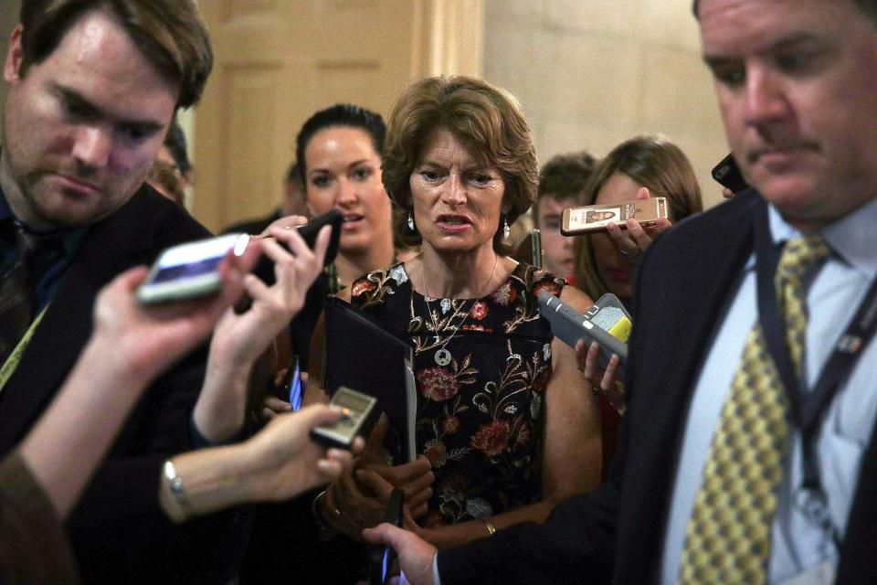Sen. Lisa Murkowski is surrounded by members of the