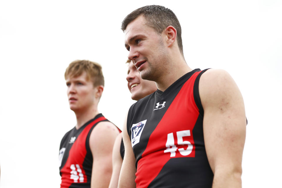 Cian McBride, Ross McQuillan and Conor McKenna of the Bombers (R) walk off after competing in the VFL curtain-raiser.