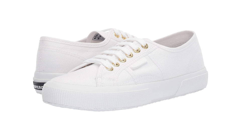 Pair of white canvas sneakers shown heel to toe.