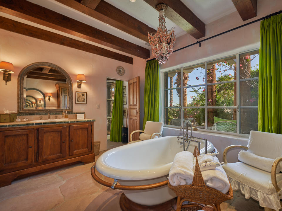 Luxuriate in the claw-foot tub and rock shower. (Credit: Douglas Elliman)