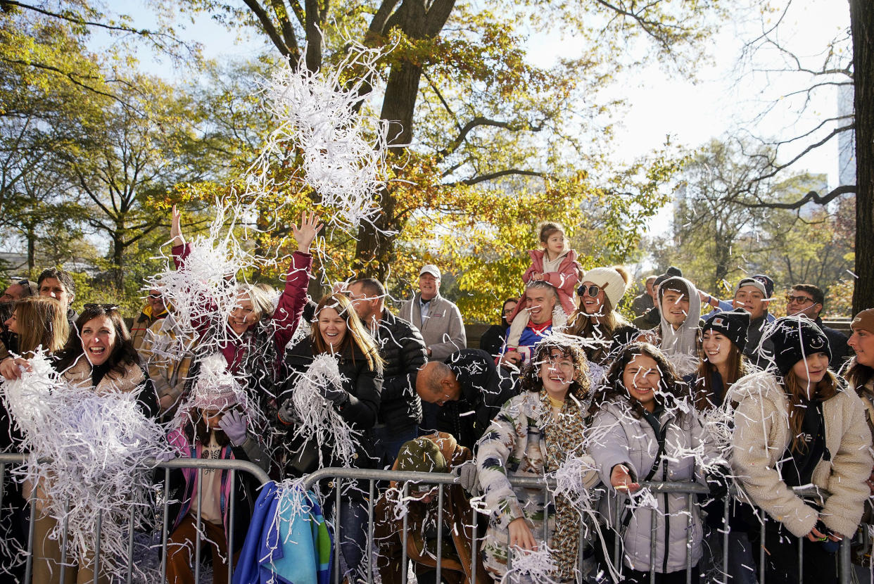 Spectators toss confetti as the parade makes its way down Central Park Avenue West during the Macy's Thanksgiving Day Parade, Nov. 24, 2022, in New York. (Julia Nikhinson / AP)