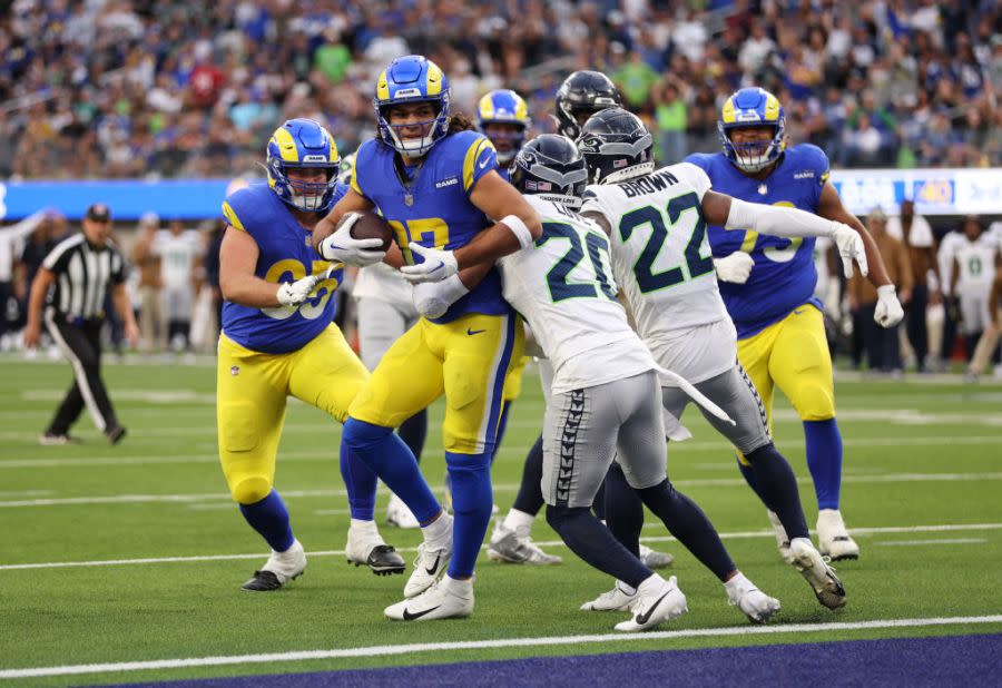 Puka Nacua #17 of the Los Angeles Rams scores a touchdown while defended by Julian Love #20 and Tre Brown #22 of the Seattle Seahawks during the second quarter at SoFi Stadium on November 19, 2023 in Inglewood, California. (Photo by Sean M. Haffey/Getty Images)