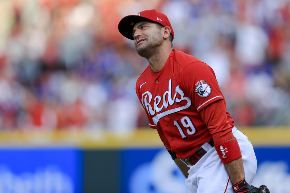 Cincinnati Reds' Joey Votto reacts to teammates after making a catch in foul territory on a ball hit by Chicago Cubs' Kris Bryant for the final out of a baseball game in Cincinnati, Saturday, July 3, 2021. The Reds won 3-2. (AP Photo/Aaron Doster)