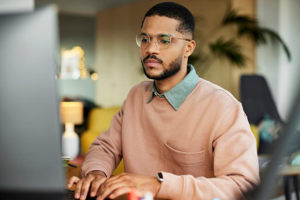 An investor studies something on a computer.