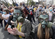 People attend a protest in front of the Serbian Parliament building in Belgrade, Serbia, Saturday, April 10, 2021. Environmental activists are protesting against worsening environmental situation in Serbia. (AP Photo/Darko Vojinovic)