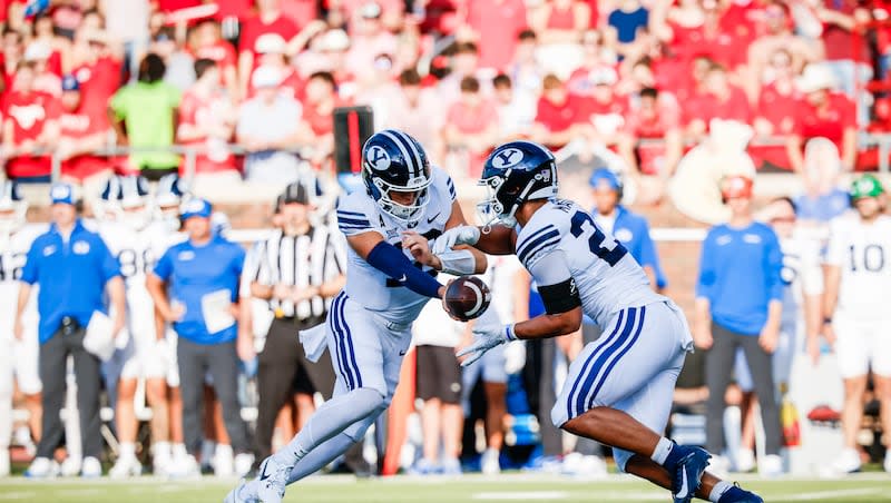 BYU's Jake Retzlaff hands off to LJ Martin during game against SMU on Sept. 6, 2024 in Dallas.