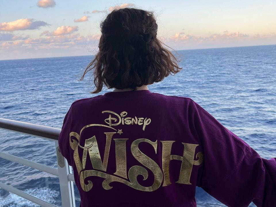 kari posing at the railing of a disney wish cruise ship - Copyright: Kari Becker