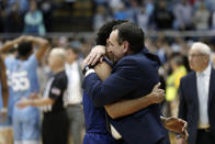 Duke guard Tre Jones hugs head coach Mike Krzyzewski following and overtime victory in an NCAA college basketball game against North Carolina in Chapel Hill, N.C., Saturday, Feb. 8, 2020. (AP Photo/Gerry Broome)