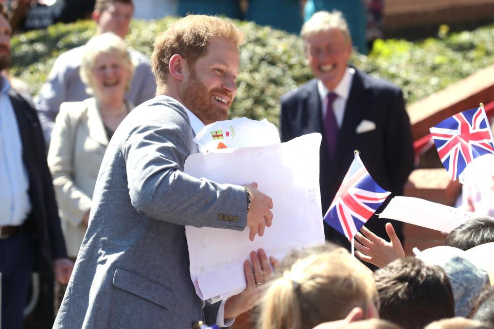 The Duke of Sussex receives gifts from well-wishers as he arrives for a visit to the Barton Neighbourhood Centre (Chris Jackson via Getty Images)