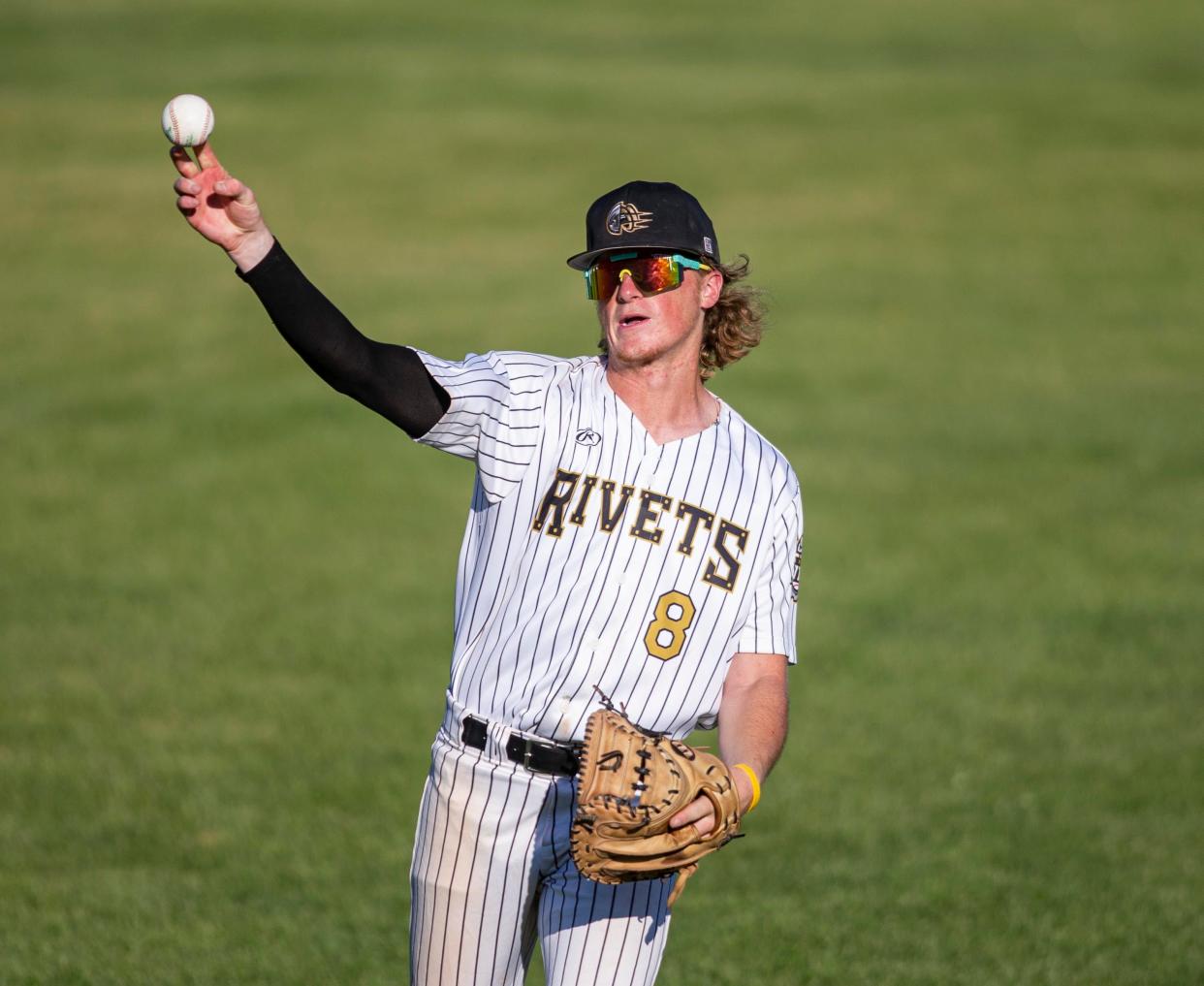 Logan Smith throws a ball during warmups on Monday, Aug. 1, 2022, at Rivets Stadium  in Loves Park. Monday's game was the team's first at home after the team bus was broken into over the weekend in Michigan resulting in a lot of their baseball equipment being stolen.