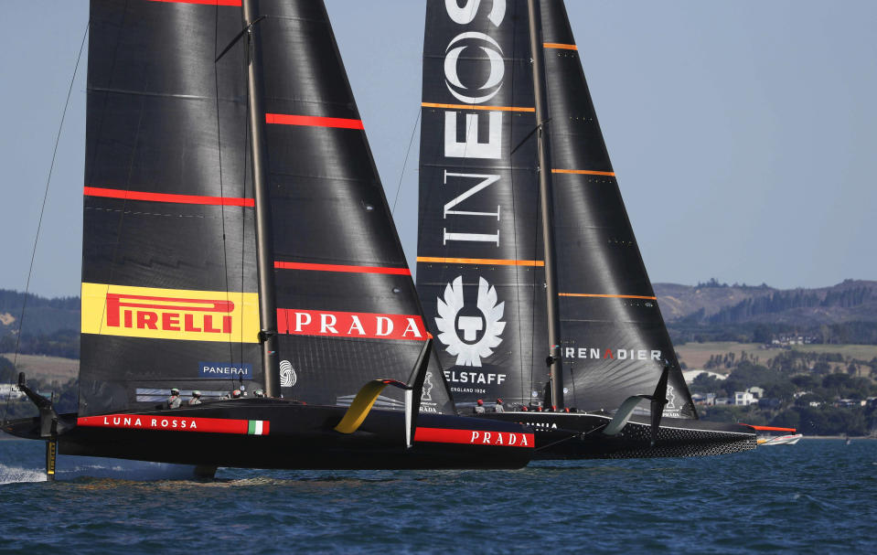 Britain's INEOS Team UK, right, leads Italy's Luna Rossa to win race six of the Prada Cup on Auckland's Waitemata Harbour, New Zealand, Saturday, Feb. 20, 2021. (Dean Purcell/NZ Herald via AP)