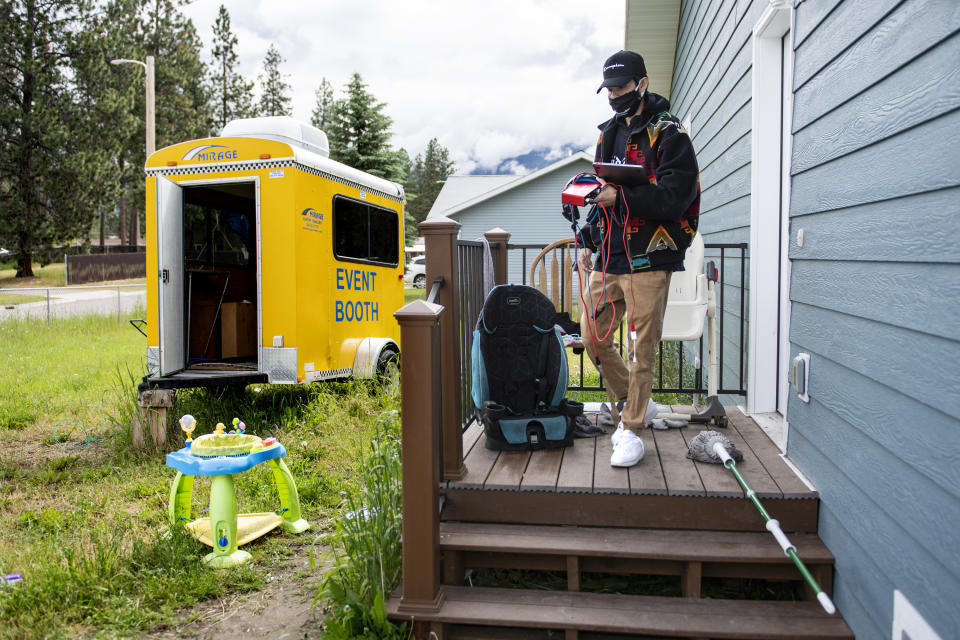 In this photo taken June 16, 2020, Artie Mendoza III, also known as KiidTruth, walks out of his home to work on a track in his home studio in Pablo, Montana. Mendoza created a viral TIk Tok dance and song to promote hand washing, mask wearing and social distancing among the youth on the Flathead Indian Reservation. (AP Photo/Tommy Martino)