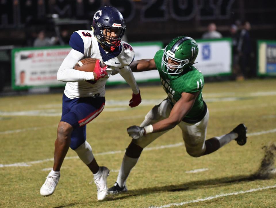 Miami Columbus wide receiver Shiloh Conway (#3) is pursued by Venice High defensive lineman Damon Wilson (#11). Venice defeated Miami Columbus 35-7 to win the Class 8A semi-final Friday night in Venice. 