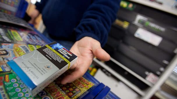 PHOTO: In this file photo, a corner store owner in St. Thomas, Ontario, Canada, holds a package of cigarettes on March 12, 2012. (Geoff Robins/AFP via Getty Images)