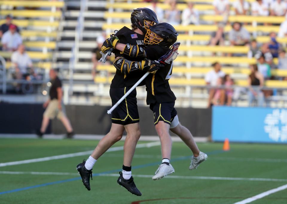 Upper Arlington's Chris Mazzaferri, left, and Charlie Paxton celebrate after Mazzaferri's goal scored against Dublin Jerome during the OHSAA Division I boys lacrosse state championship game June 4 at Historic Crew Stadium in Columbus.