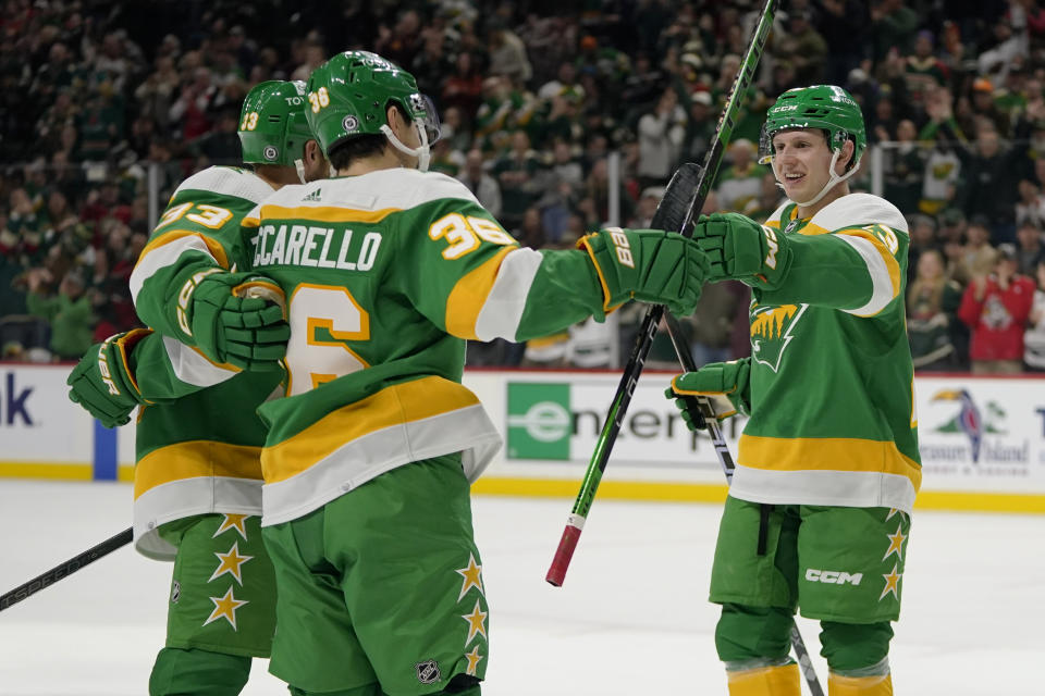 Minnesota Wild right wing Mats Zuccarello (36) celebrates with defenseman Alex Goligoski, left, and center Marco Rossi, right, after scoring during the first period of an NHL hockey game against the Chicago Blackhawks Sunday, Dec. 3, 2023, in St. Paul, Minn. (AP Photo/Abbie Parr)