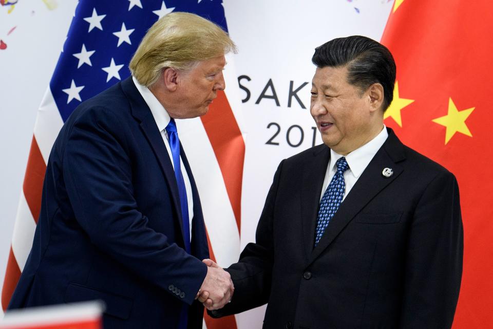 (FILES) In this file photo taken on June 28, 2019, China's President Xi Jinping (R) shakes hands with US President Donald Trump before a bilateral meeting on the sidelines of the G20 Summit in Osaka. - From the Arab Spring to bloodletting in Syria, from Obama to Trump, from terror in the streets of Paris to Brexit, the 2010s began with hope for a more equitable world, and end with a slide towards nationalistic populism. (Photo by Brendan Smialowski / AFP) (Photo by BRENDAN SMIALOWSKI/AFP via Getty Images)