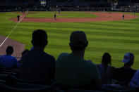 Baseball fans watch the Atlanta Braves and the Boston Red Sox play during a spring training baseball game on Monday, March 1, 2021, in Fort Myers, Fla. (AP Photo/Brynn Anderson)