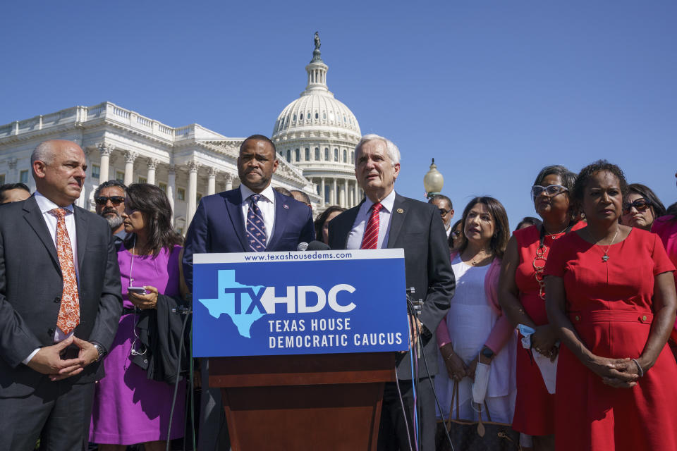 Rep. Marc Veasey, D-Texas, center left, and Rep. Lloyd Doggett, D-Texas, joined at left by Rep. Chris Turner, chairman of the Texas House Democratic Caucus, welcome Democratic members of the Texas legislature at a news conference at the Capitol in Washington, Tuesday, July 13, 2021. The lawmakers left Austin hoping to deprive the Texas Legislature of a quorum — the minimum number of representatives who have to be present for the body to operate, as they try to kill a Republican bill making it harder to vote in the Lone Star State. (AP Photo/J. Scott Applewhite)