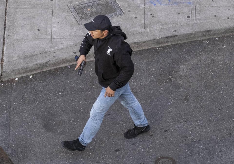 A man holds what appears to be a firearm after having driven at George Floyd protesters Sunday, June 7, 2020, in Seattle.