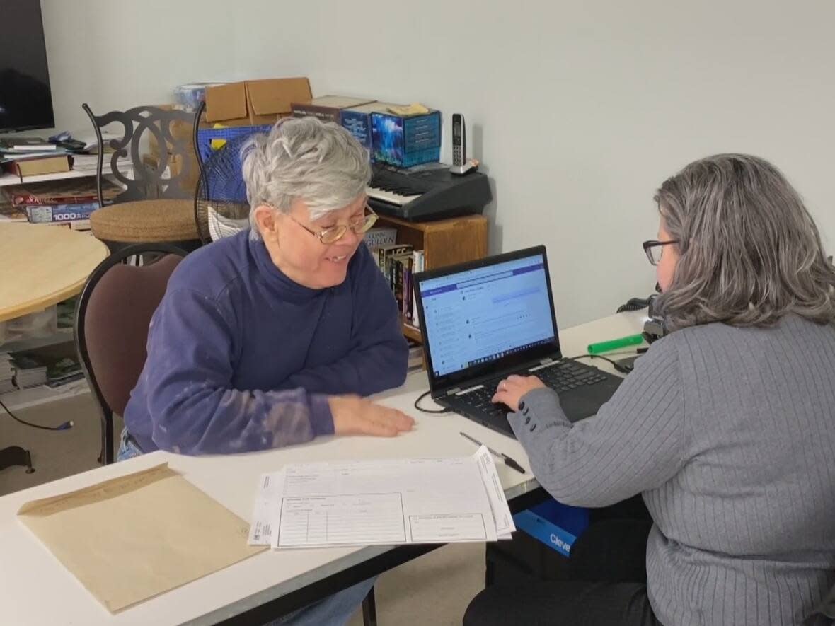 Craig Putt gets help filing his taxes through the Returning Hope program at Souls Harbour Rescue Mission in Halifax on Monday afternoon.  (Anam Khan/CBC - image credit)