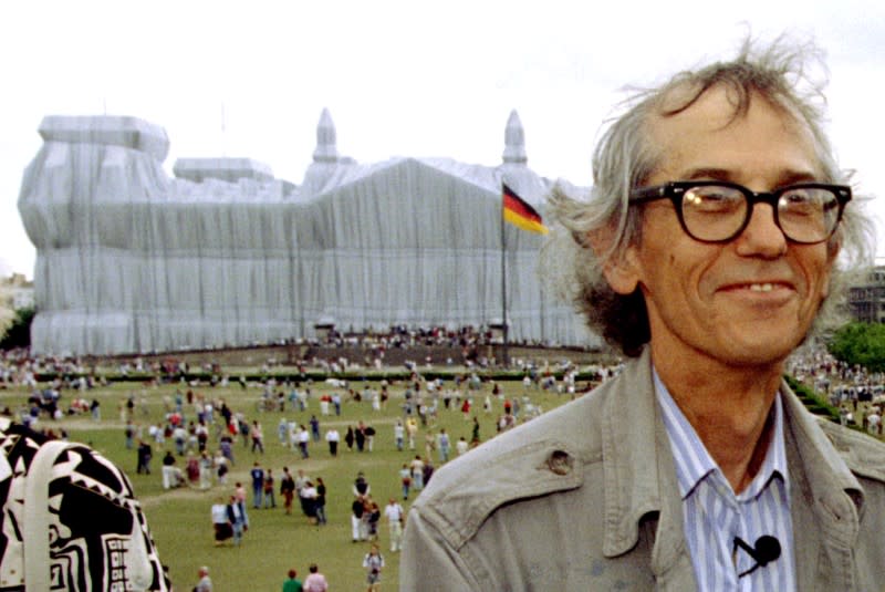 FILE PHOTO: Conceptual artist Christo poses for photographers in front of the wrapped Reichstag