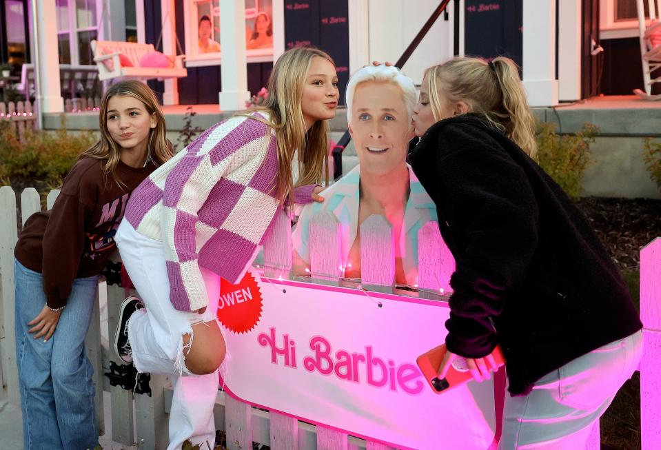 Devry Reeder, Hailee Seaman and Chelsie Petersen pose for a photo with a cutout of Ken while exploring a Daybreak neighborhood that is decorated in a “Barbie” theme for Halloween in South Jordan on Friday, Oct. 13, 2023. | Kristin Murphy, Deseret News