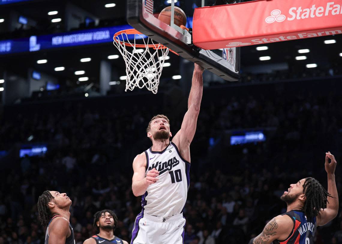 Sacramento Kings center Domantas Sabonis (10) drives for a shot in front of Brooklyn Nets forward Trendon Watford (9) during the first half Sunday, April 7, 2024, at Barclays Center in Brooklyn, New York.