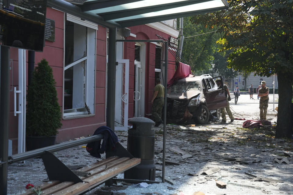 Ukrainian servicemen inspect a damaged area after a Russian attack in Chernihiv, Ukraine, Saturday, Aug. 19, 2023. (AP Photo/Efrem Lukatsky)