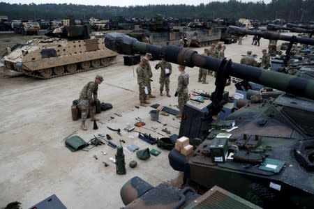 FILE PHOTO: U.S. troops from 2nd Armored Brigade Combat Team, 1st Armored Division check military equipment after their deployment to Poland for military exercises in Drawsko Pomorskie training area
