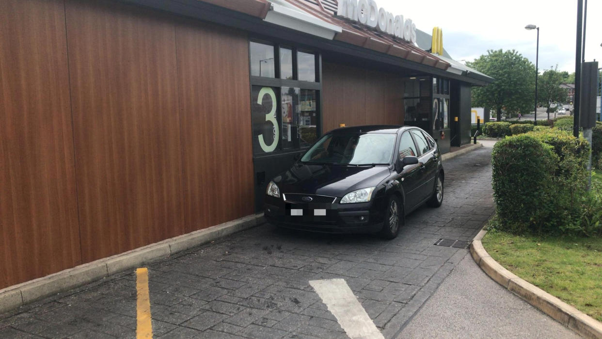 A customer used his car to block a McDonald's drive-thru in Leyland, Lancashire, on Sunday. (SWNS)