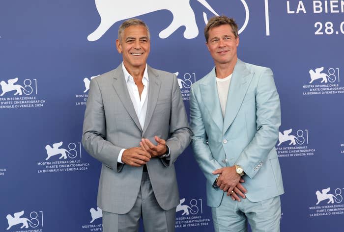 George Clooney and Brad Pitt at the 2024 Venice Biennale, in elegant suits, smiling against the backdrop of the Venice Film Festival