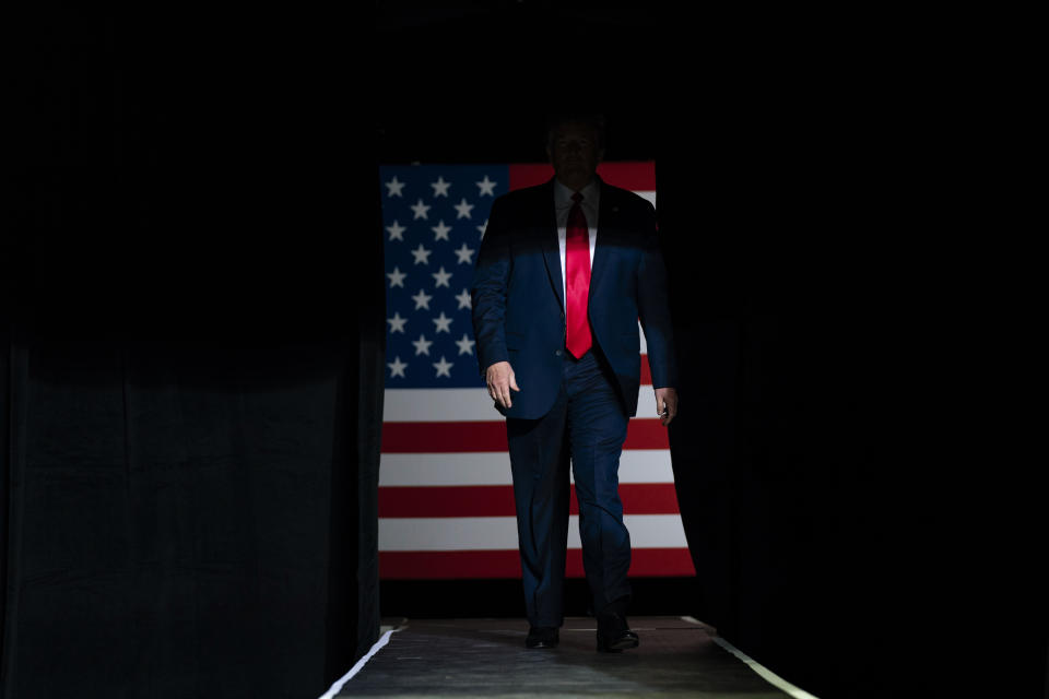 President Donald Trump arrives on stage to speak at a campaign rally at the BOK Center in Tulsa, Okla., on Saturday, June 20, 2020. (AP Photo/Evan Vucci)