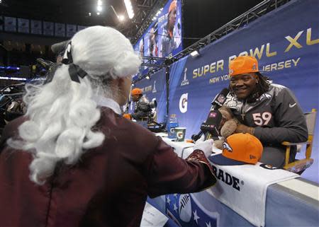 Denver Broncos outside linebacker Danny Trevathan is interviewed by a reporter dressed in a period costume during Media Day for Super Bowl XLVIII at the Prudential Center in Newark, New Jersey January 28, 2014. REUTERS/Shannon Stapleton