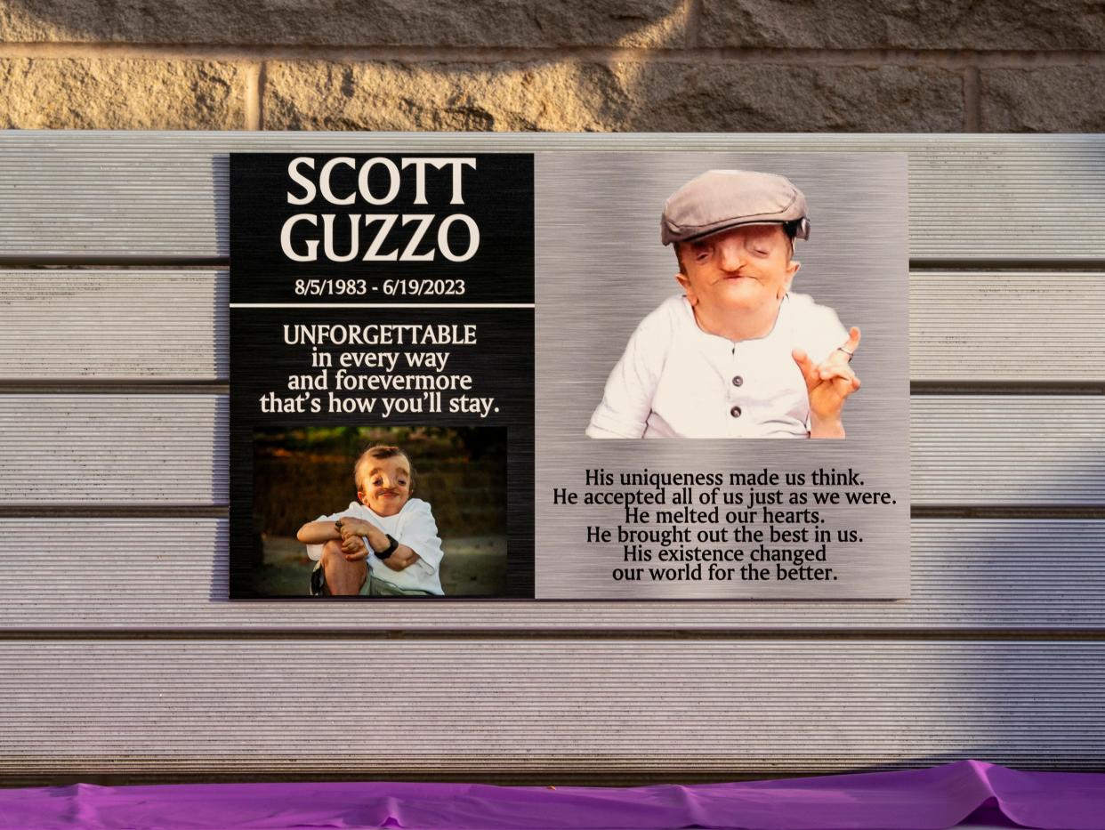 A bench dedicated to Scott Guzzo was dedicated outside the Ford Center during a ceremony Thursday, Oct. 25, 2023. Guzzo was diagnosed with Crane-Heise syndrome, a rare craniofacial condition, at age 10. He was an advocate for the disabled and beloved community member who died in June at age 39.