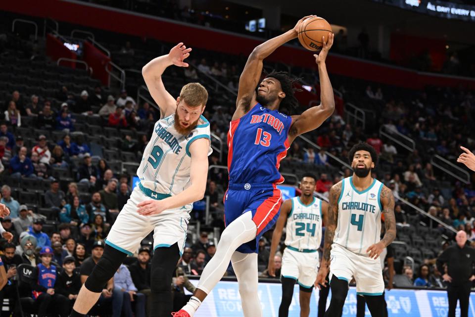 Detroit Pistons center James Wiseman (13) drives to the basket against Charlotte Hornets forward Davis Bertans (9) in the fourth quarter at Little Caesars Arena in Detroit on Monday, March 11, 2024.