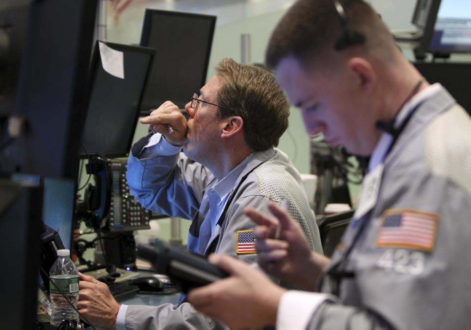 Traders work on the floor at the New York Stock Exchange in New York, Wednesday, Oct. 31, 2012.Traffic is snarled, subways out of commission, streets flooded and power out in many parts of the city, but the New York Stock Exchange opened without hitch Wednesday after an historic two-day shutdown, courtesy of Supertorm Sandy. (AP Photo/Seth Wenig)