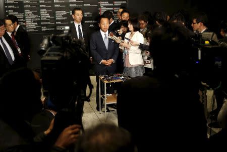 Japan's Economics Minister Akira Amari speaks to reporters after a meeting with U.S. Trade Representative Michael Froman in Tokyo April 19, 2015. REUTERS/Yuya Shino