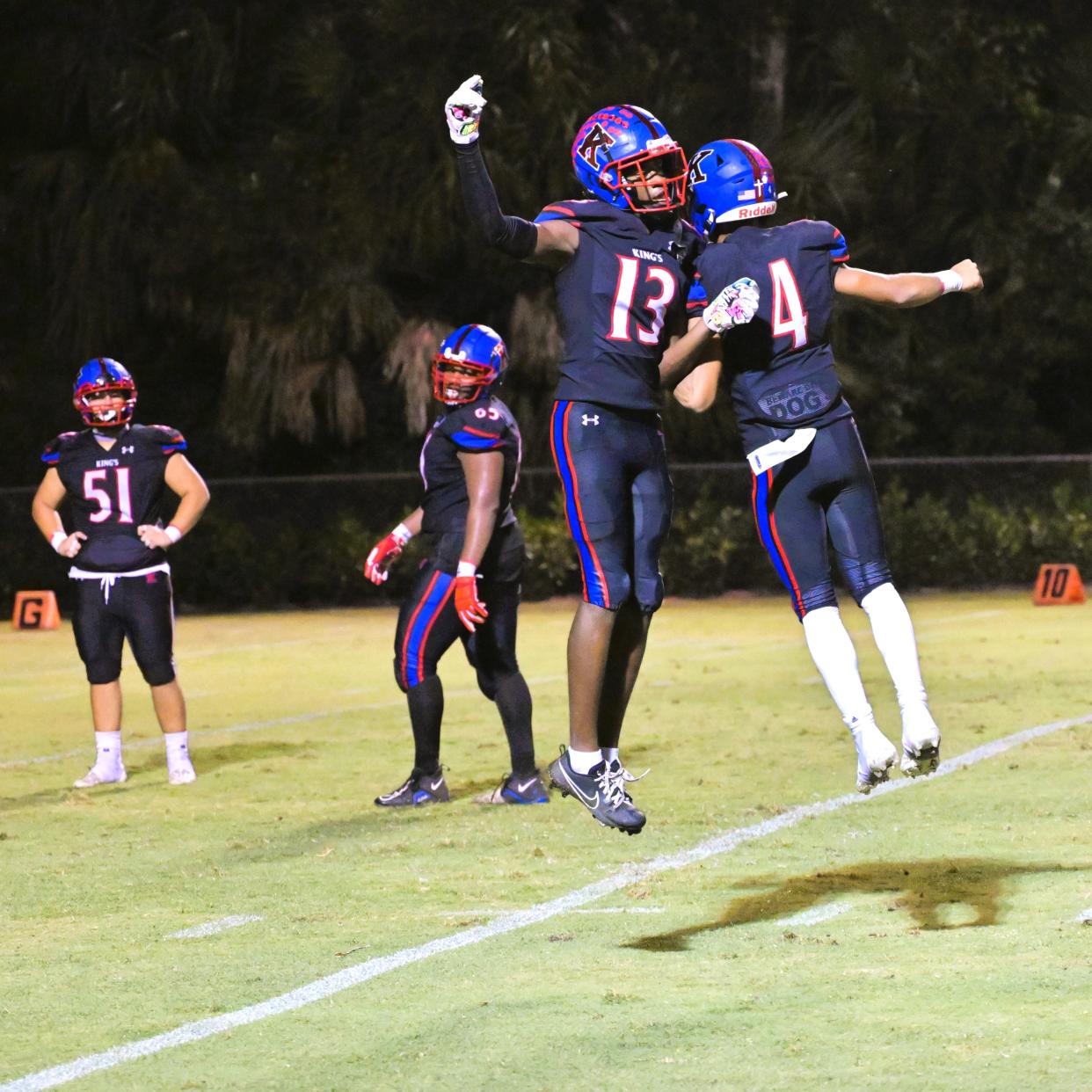 King’s Academy’s Javian Jones and Reggie Workman celebrate after connecting on a game-saving 85-yard touchdown to retake the lead late in the fourth quarter against Gulliver Prep (Sept 22, 2023).