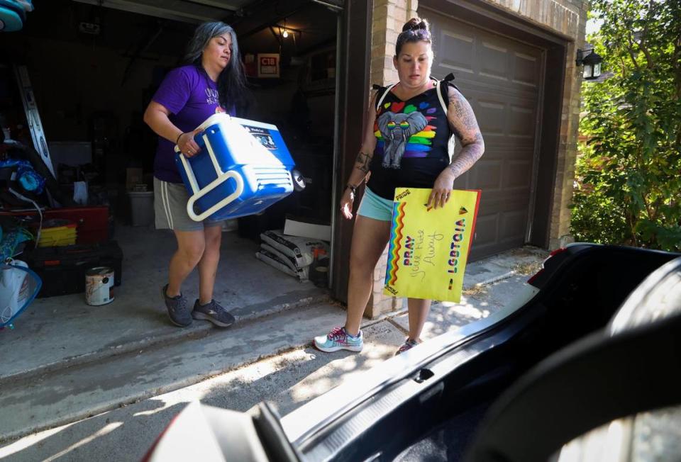 “There’s no way for us not to feel, think and believe that it’s just a matter of time before someone from that congregation decides to take up arms and do his bidding,” says Mandi Skinner as she and her wife, Theresa Izaguirre, left, prepare to head to a protest outside Stedfast Baptist Church. “They’re so close to our home, there’s no way that we can’t be a little bit afraid of that.”