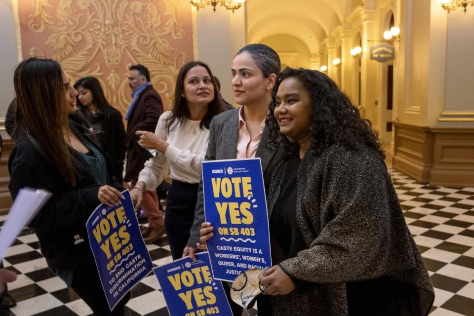 Califiornia state Sen. Aisha Wahab, center, with Thenmozhi Soundararajan, right,